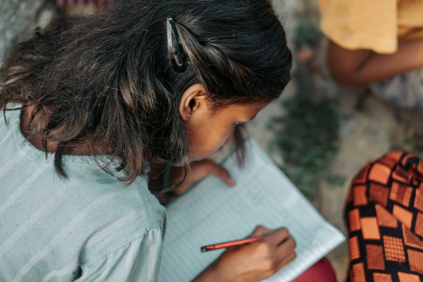 Comment choisir une école privée à Antananarivo ? Les critères essentiels pour bien préparer la rentrée – Une jeune élève travaille avec concentration sur un exercice. Cette scène illustre l'importance d'un apprentissage rigoureux et d'un accompagnement de qualité dans une école primaire.